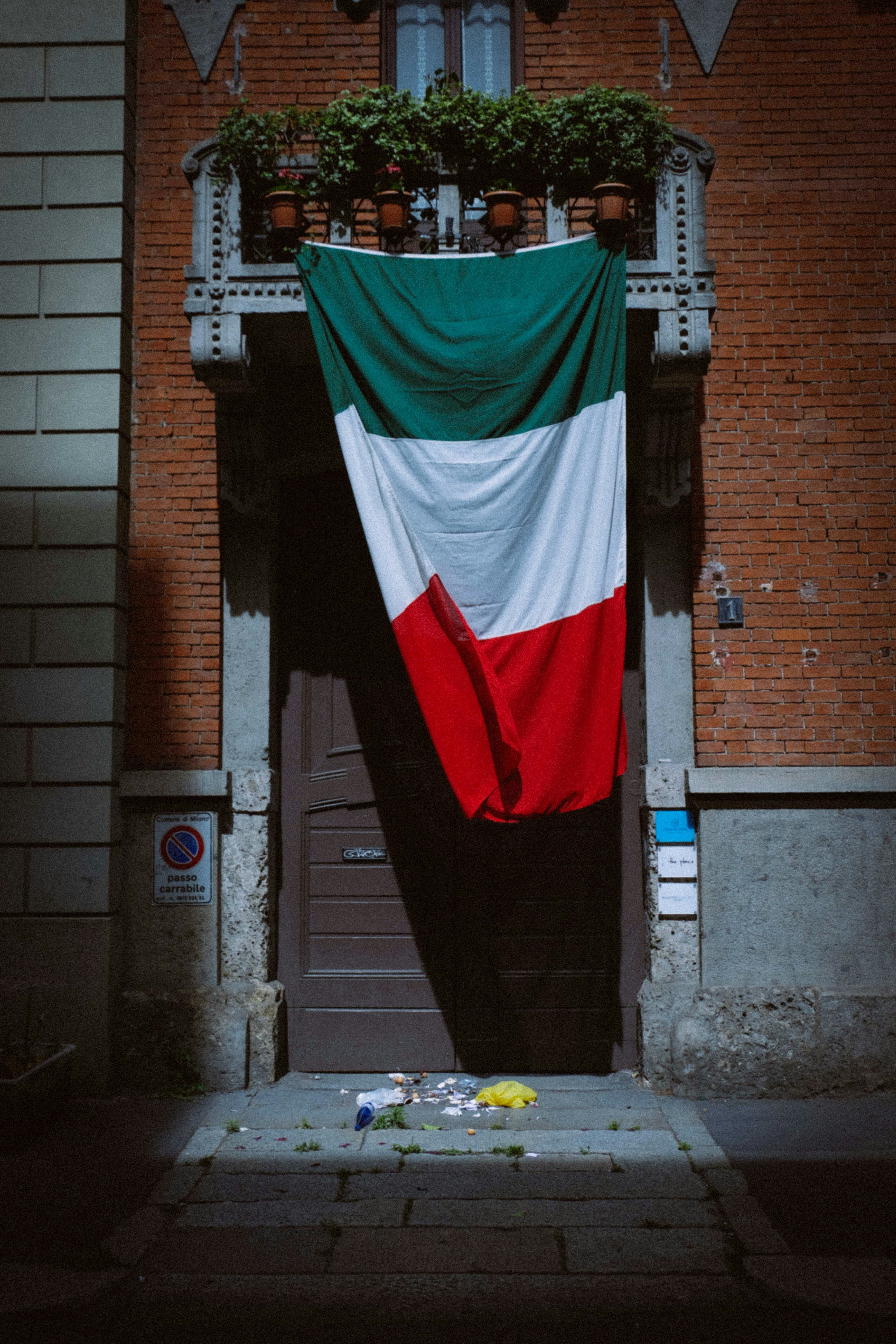 red white and green flag on brown brick wall